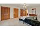 A well-lit primary bedroom features hardwood doors, a ceiling fan, and carpet flooring at 1778 Woodcrest Ln, Deland, FL 32720
