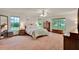 Spacious main bedroom with neutral colored carpet, multiple windows, and ample natural light at 1778 Woodcrest Ln, Deland, FL 32720