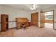 This office features a traditional roll-top desk, wood-look flooring, and access to the kitchen at 1778 Woodcrest Ln, Deland, FL 32720