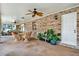 Covered patio features brick walls, ceiling fans and comfortable seating area at 1778 Woodcrest Ln, Deland, FL 32720
