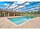 Backyard features a screened in pool, brick pavers, covered patio and fenced in yard at 1778 Woodcrest Ln, Deland, FL 32720