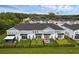 Aerial view of modern townhomes featuring fenced yards with patios, backing onto lush green spaces, perfect for outdoor living at 1932 Terrapin Rd, Ocoee, FL 34761