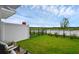 A well-maintained backyard with plush green grass, black fencing, and a view of a serene pond at 1932 Terrapin Rd, Ocoee, FL 34761