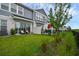 A lovely backyard with green grass, a patio with seating, and a black fence with a view of other units at 1932 Terrapin Rd, Ocoee, FL 34761