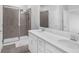 Modern bathroom with double sinks, walk-in shower, and white cabinets at 1932 Terrapin Rd, Ocoee, FL 34761