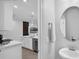 View from bathroom to kitchen with stainless appliances at 1932 Terrapin Rd, Ocoee, FL 34761