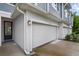 Side view of a townhome exterior with muted blue siding and a two-car garage at 1932 Terrapin Rd, Ocoee, FL 34761