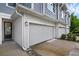 Side view of a townhome exterior with muted blue siding and a two-car garage at 1932 Terrapin Rd, Ocoee, FL 34761