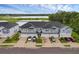Modern townhomes with attached garages face a serene lake, offering picturesque views and a peaceful community setting at 1932 Terrapin Rd, Ocoee, FL 34761