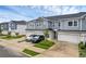 Townhome exterior featuring muted blue siding, a two-car garage, and a well maintained lawn and garden at 1932 Terrapin Rd, Ocoee, FL 34761