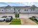 Attractive townhome exterior featuring muted blue siding, two-car garages, and manicured landscaping at 1932 Terrapin Rd, Ocoee, FL 34761