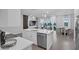 Open kitchen with center island, stainless steel dishwasher, and views to the living and dining areas at 1932 Terrapin Rd, Ocoee, FL 34761