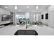 Open-concept kitchen with island sink, bar seating and adjacent living room with decorative fireplace at 1932 Terrapin Rd, Ocoee, FL 34761
