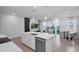 Modern kitchen with center island, stainless dishwasher, and views of the living and dining room at 1932 Terrapin Rd, Ocoee, FL 34761