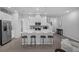 Bright kitchen features a large center island with seating, stainless steel appliances, and modern white cabinetry at 1932 Terrapin Rd, Ocoee, FL 34761