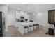 Beautiful kitchen with stainless steel appliances, island with seating, and an open view into the living room at 1932 Terrapin Rd, Ocoee, FL 34761