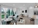 Bright, neutral living space with tile flooring, white curtains, modern furniture, and natural light at 1932 Terrapin Rd, Ocoee, FL 34761