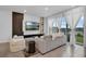 Cozy living room featuring a modern entertainment center and sliding glass doors at 1932 Terrapin Rd, Ocoee, FL 34761