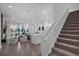 Open living space features stairs, kitchen, dining area and doors leading to backyard at 1932 Terrapin Rd, Ocoee, FL 34761