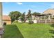 Lush backyard featuring a green lawn with mature trees and a privacy fence at 1932 Westpointe Cir, Orlando, FL 32835
