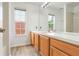 Bright bathroom features a double vanity, large mirror, and natural light from two windows at 1932 Westpointe Cir, Orlando, FL 32835