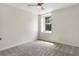 Bright bedroom with neutral colors, carpet, and a large window overlooking a yard at 1932 Westpointe Cir, Orlando, FL 32835