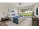 Light and bright staged bedroom with neutral colors and a large window overlooking the back yard at 1932 Westpointe Cir, Orlando, FL 32835
