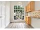 Bright breakfast nook with view of backyard. Features light wood cabinets and a serving counter at 1932 Westpointe Cir, Orlando, FL 32835