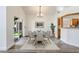 Cozy dining room with modern table set, hardwood floors, and view into kitchen area at 1932 Westpointe Cir, Orlando, FL 32835