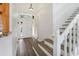 Welcoming foyer with hardwood floors, a staircase, and a clear view of the front door and outdoor space at 1932 Westpointe Cir, Orlando, FL 32835