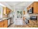 Modern kitchen with stainless steel appliances, granite countertops, and a view of the backyard at 1932 Westpointe Cir, Orlando, FL 32835