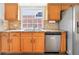 Bright kitchen with stainless steel appliances, tile backsplash and light wood cabinets and hardware at 1932 Westpointe Cir, Orlando, FL 32835