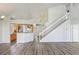 Spacious living room with hardwood floors, staircase, and views of the kitchen and entryway at 1932 Westpointe Cir, Orlando, FL 32835