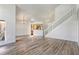 Open-concept living room featuring hardwood floors, a staircase, and a view of the kitchen area at 1932 Westpointe Cir, Orlando, FL 32835