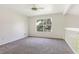Neutral room featuring carpet, a ceiling fan, and a large window for natural light at 1932 Westpointe Cir, Orlando, FL 32835