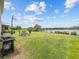 Expansive backyard featuring a barbecue grill, dining set, and scenic lake view at 2105 Lake Side Ave, Davenport, FL 33837