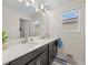 Bright bathroom with a double sink vanity, a large mirror, and ample lighting at 2105 Lake Side Ave, Davenport, FL 33837