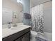 Bright bathroom features a shower-tub combo, a white vanity with a solid surface counter, and decorative accents at 2105 Lake Side Ave, Davenport, FL 33837