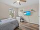 Cozy bedroom featuring wood floors, a ceiling fan, a dresser, and a window at 2105 Lake Side Ave, Davenport, FL 33837