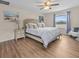 Serene bedroom with warm wood floors, a large bed with plush pillows, and a window for natural light at 2105 Lake Side Ave, Davenport, FL 33837