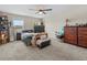 Eclectic bedroom with ceiling fan, carpet, multiple windows, and lots of personal touches at 2105 Lake Side Ave, Davenport, FL 33837
