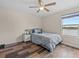 Bedroom featuring wood floors, a ceiling fan, a lake view and a gray color scheme at 2105 Lake Side Ave, Davenport, FL 33837