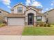 Charming two-story home with a brick-paved driveway and well-kept lawn in a sunny neighborhood at 2105 Lake Side Ave, Davenport, FL 33837