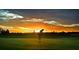 Golfer on lush green course at sunset at 2105 Lake Side Ave, Davenport, FL 33837