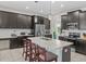 Modern kitchen with stainless steel appliances, dark cabinetry, and a spacious center island with barstool seating at 2105 Lake Side Ave, Davenport, FL 33837