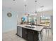 Bright kitchen with a center island, stainless steel dishwasher, and views to the living room and dining area at 2105 Lake Side Ave, Davenport, FL 33837