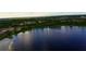 The lake is surrounded by mature trees at 2105 Lake Side Ave, Davenport, FL 33837