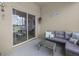 Relaxing screened patio with a comfortable sectional couch and an outdoor dining area, overlooking the lake at 2105 Lake Side Ave, Davenport, FL 33837