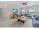 Bright living room featuring tile floors, a ceiling fan, large windows, and modern furniture at 2105 Lake Side Ave, Davenport, FL 33837