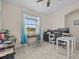The office features tiled floors, a ceiling fan, and a large window allowing for ample natural light at 2105 Lake Side Ave, Davenport, FL 33837